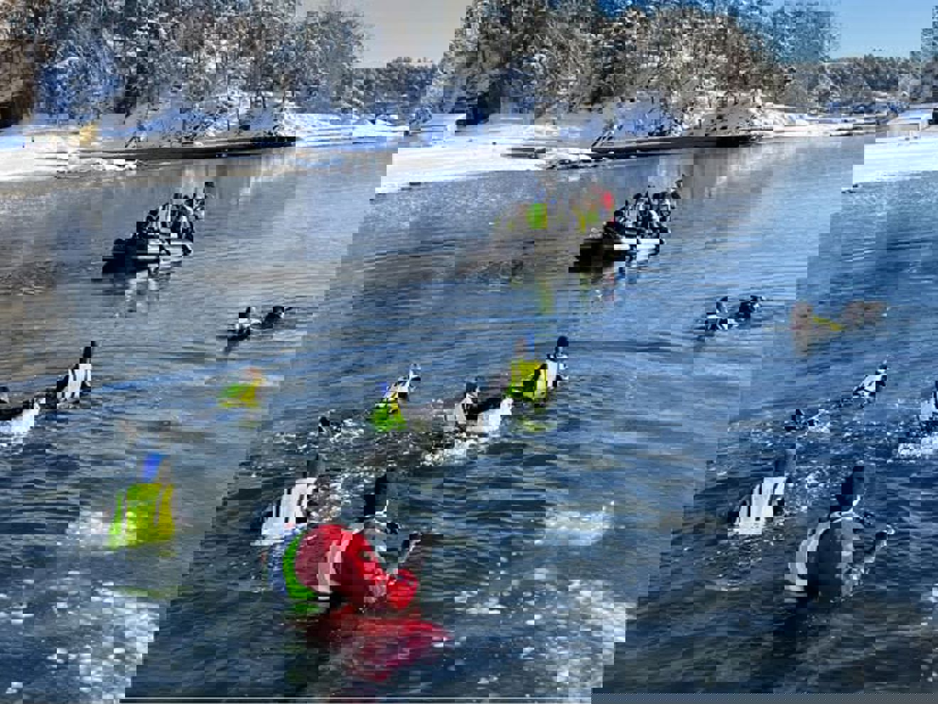 En gruppe mennesker i kajakker i en innsjø